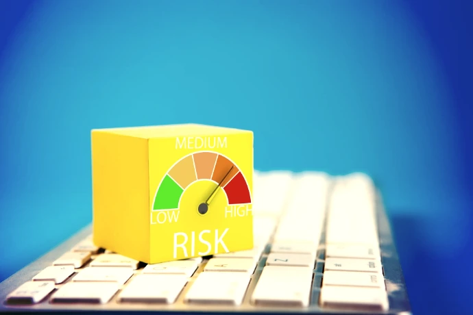 Yellow cube with risk meter on keyboard